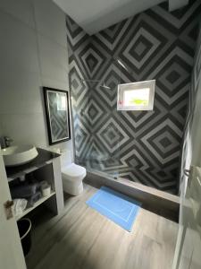 a bathroom with a toilet and a wall at La Casa Sorento in Victoria