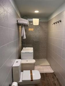 a small bathroom with a toilet and a shower at Cozy apartment Costa Adeje in Adeje