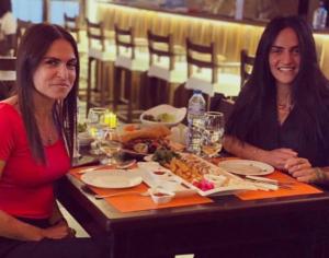 two women sitting at a table with a plate of food at Mount Nebo Hotel & Restaurant Madaba City Center in Madaba