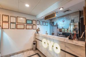 a restaurant with a counter with a sign on the wall at OYO 671 Hotel Capitol in Jakarta