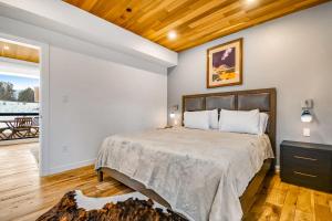 a bedroom with a large bed with a wooden ceiling at Tree Farm Sanctuary in Basalt