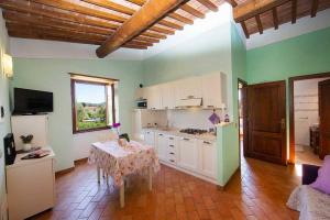 a kitchen with a table and a kitchen with a table and a tableablish at Villa Aiali in Marina di Campo