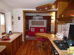 a kitchen with a stove and a counter top at Maison al Lago in Alleghe