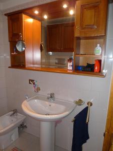 a bathroom with a sink and a toilet at Maison al Lago in Alleghe