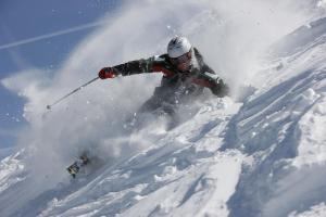 a person is skiing down a snow covered slope at Maison al Lago in Alleghe
