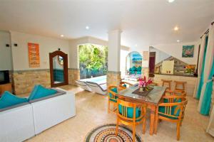 a living room with a couch and a table at Largest Villa in Kuta Royal C1 - Turquoise Villa in Kuta