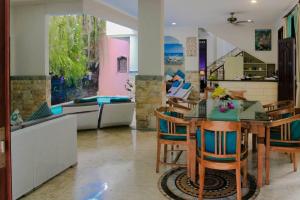 a dining room and living room with a table and chairs at Largest Villa in Kuta Royal C1 - Turquoise Villa in Kuta