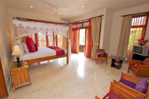 a bedroom with a bed and a living room at Largest Villa in Kuta Royal C1 - Turquoise Villa in Kuta +59 photos