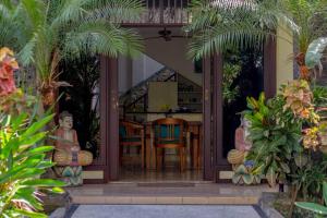 a patio with a table and chairs in a house at Largest Villa in Kuta Royal C1 - Turquoise Villa in Kuta