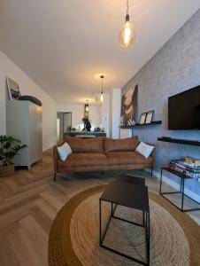 a living room with a couch and a tv at Heiligeweg 48 in Harlingen