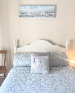 a bedroom with a bed with a pillow on it at Village Way Apartments in Kincasslagh