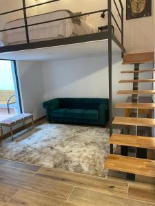 a living room with a bunk bed and a staircase at Loft en Montjuic in Barcelona