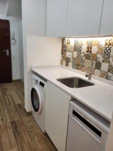 a kitchen with a sink and a washing machine at Loft en Montjuic in Barcelona