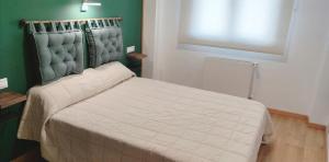 - une chambre dotée d'un lit avec un mur vert dans l'établissement Apartamento Piscina y Playa, à San Juan de la Arena