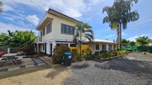 a house with a yellow fence in front of it at Mapusagas Riverside x2Bedrooms Home away from home #4 Sleeps 2-6 in Apia