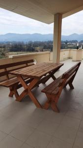 a wooden picnic table and bench on a roof at Il Chicco apartment in Lamporecchio