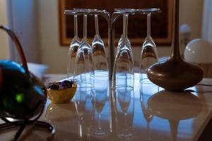 a group of wine glasses sitting on a table at DolceVita Suite Boutique in Bologna