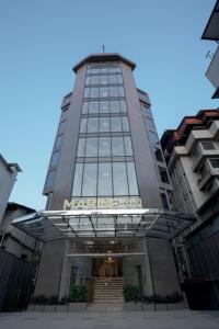 a building with a sign on the front of it at Marine Inn Hotel in Cochin