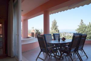 a table and chairs on a balcony with a view at StarLight SeaView in Gouvia
