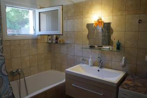 a bathroom with a sink and a bath tub at StarLight SeaView in Gouvia