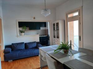 a living room with a blue couch and a table at Apartman Soda in Ogulin