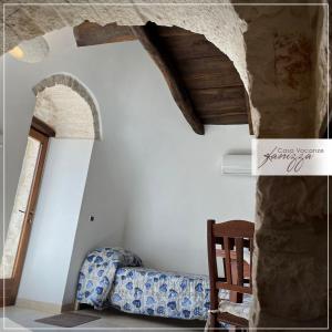 a living room with a couch and a stone wall at Trullo della Selva in Alberobello