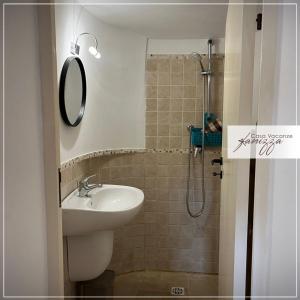 a bathroom with a sink and a shower at Trullo della Selva in Alberobello