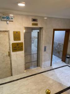 a bathroom with a glass door in a building at أبو بندر للشقق المخدومة in Ar Rass