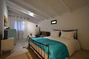 a bedroom with a large bed and a couch at Sideroporta castle Náfpaktos in Nafpaktos