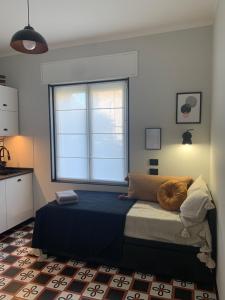 a bedroom with a bed with a large window at Design studio Margherita in Cinisello Balsamo