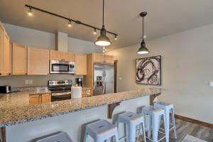 a kitchen with a counter and stools in a room at Montana Vacation Rental - Fish, Hike, Ski! in Columbia Falls