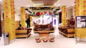 a lobby with couches and decorations in a store at BRINJAL HOTELS, HARIDWAR in Haridwār