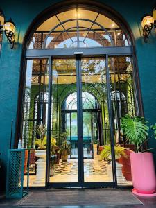 an entrance to a building with a large glass door at La Habana Hua Hin Condo Pool View 1 Bed Room in Hua Hin