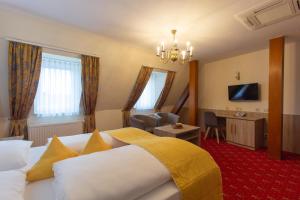 a hotel room with a large bed and a desk at Hotel Residence in Würzburg