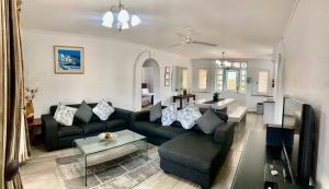 a living room with a couch and a table at 43 Montego Bay, Caribbean Estate in Port Edward