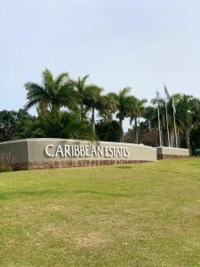 a sign for a park with palm trees in the background at 43 Montego Bay, Caribbean Estate in Port Edward