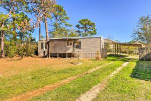 an exterior view of a house with a yard at Cozy Gulf Breeze Home, 3 Mi to East Bay! in Navarre