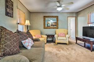 a living room with a couch and a flat screen tv at Cozy Gulf Breeze Home, 3 Mi to East Bay! in Navarre
