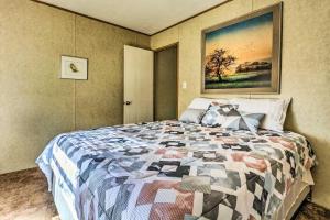 a bedroom with a bed with a quilt on it at Cozy Gulf Breeze Home, 3 Mi to East Bay! in Navarre