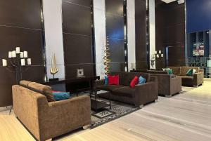 a lobby with couches and chairs in a room at Ramada Suites by Wyndham Kuala Lumpur City Centre in Kuala Lumpur