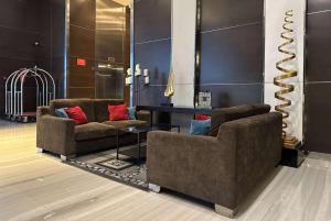 a lobby with two couches and a table at Ramada Suites by Wyndham Kuala Lumpur City Centre in Kuala Lumpur