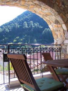 a balcony with two chairs and a view of a mountain at Kastorio-Villy's Guest House in Kastórion