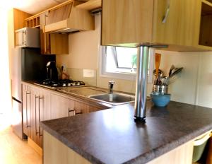 a kitchen with a sink and a counter top at Vechtdal Beerze Buren in Beerze