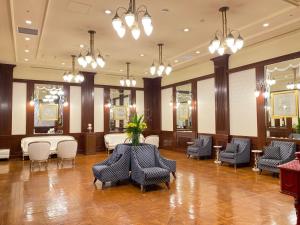 a waiting room with chairs and tables and lights at Hotel Monterey Edelhof Sapporo in Sapporo