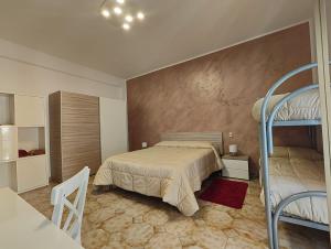 a bedroom with a bed and a bunk bed at Isola sul mare breve il centro in Castellammare del Golfo