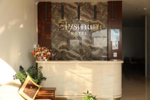 a hotel lobby with a sign that reads hy infinity hotel at Elysinam Boutique Hotel Ha Long in Ha Long