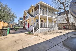 a yellow house with a porch on a street at Spacious Midtown Houston Home with Deck! in Houston