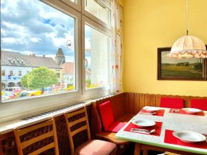 ein Esszimmer mit einem Tisch und einem Fenster in der Unterkunft Gasthof Großmann in Heidenreichstein