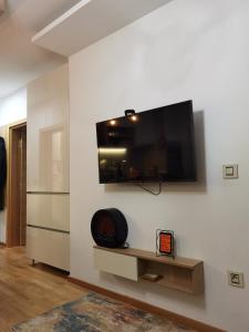 ein Wohnzimmer mit einem Flachbild-TV an der Wand in der Unterkunft Zlatibor apartman 34 Wellness&Spa in Zlatibor
