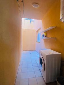 a bathroom with a washing machine in a room at Sun&Beach 5 in Caleta De Fuste